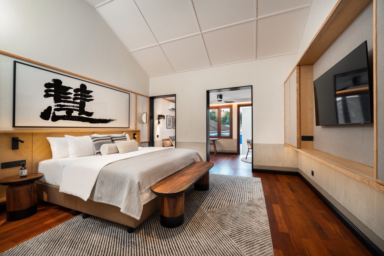 Terrace Suite bedroom with repaired traditional panel ceiling and salvaged timber flooring