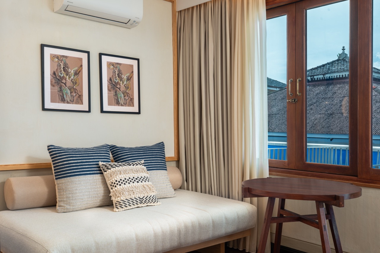 Terrace Suite lounge area with timber-framed doors opening to the rooftop garden