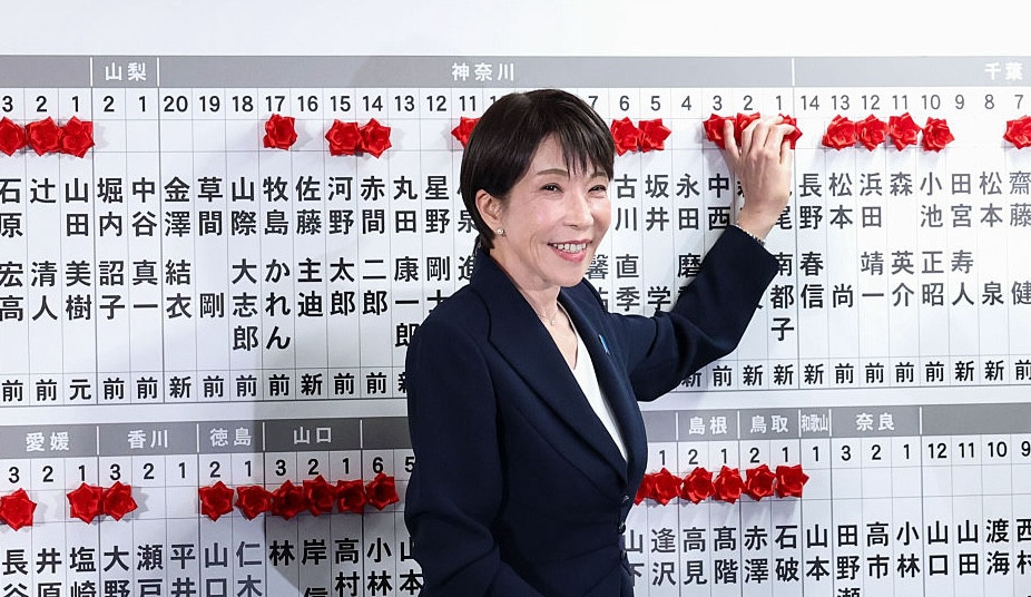 Japan's Prime Minister Sanae Takaichi, leader of the ruling Liberal Democratic Party (LDP), places a red paper rose on the name of an elected candidate at the LDP headquarters on general election day in Tokyo, Japan, February 8, 2026. REUTERS/Kim Kyung-Hoon/Pool