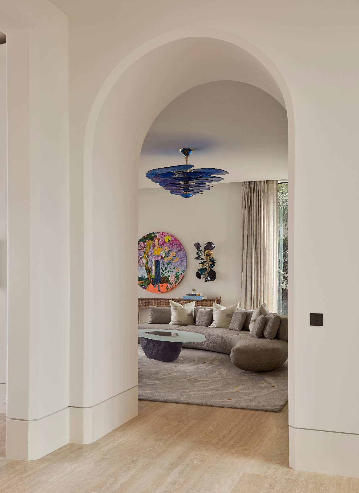 A glimpse of the living room in a waterfront Miami Beach home designed by Strang Architects with Pembrooke + Ives
