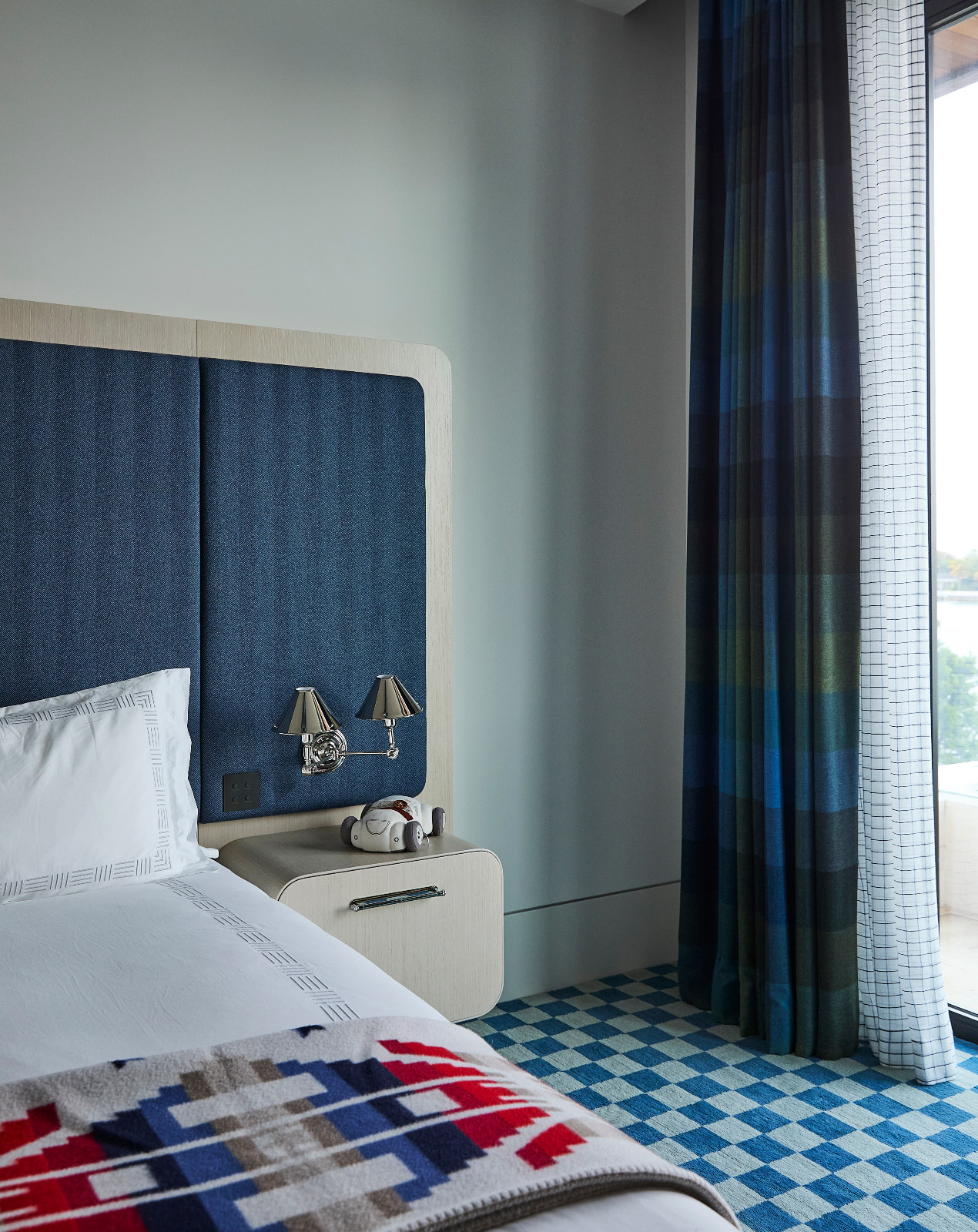 The bedroom in a waterfront Miami Beach home designed by Strang Architects with Pembrooke + Ives