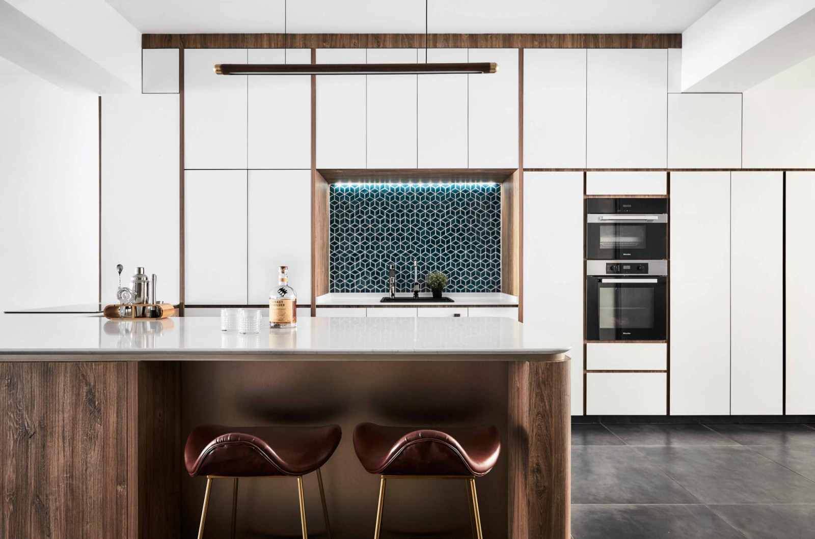 A minimalist kitchen gets a visual lift from its patterned backsplash
