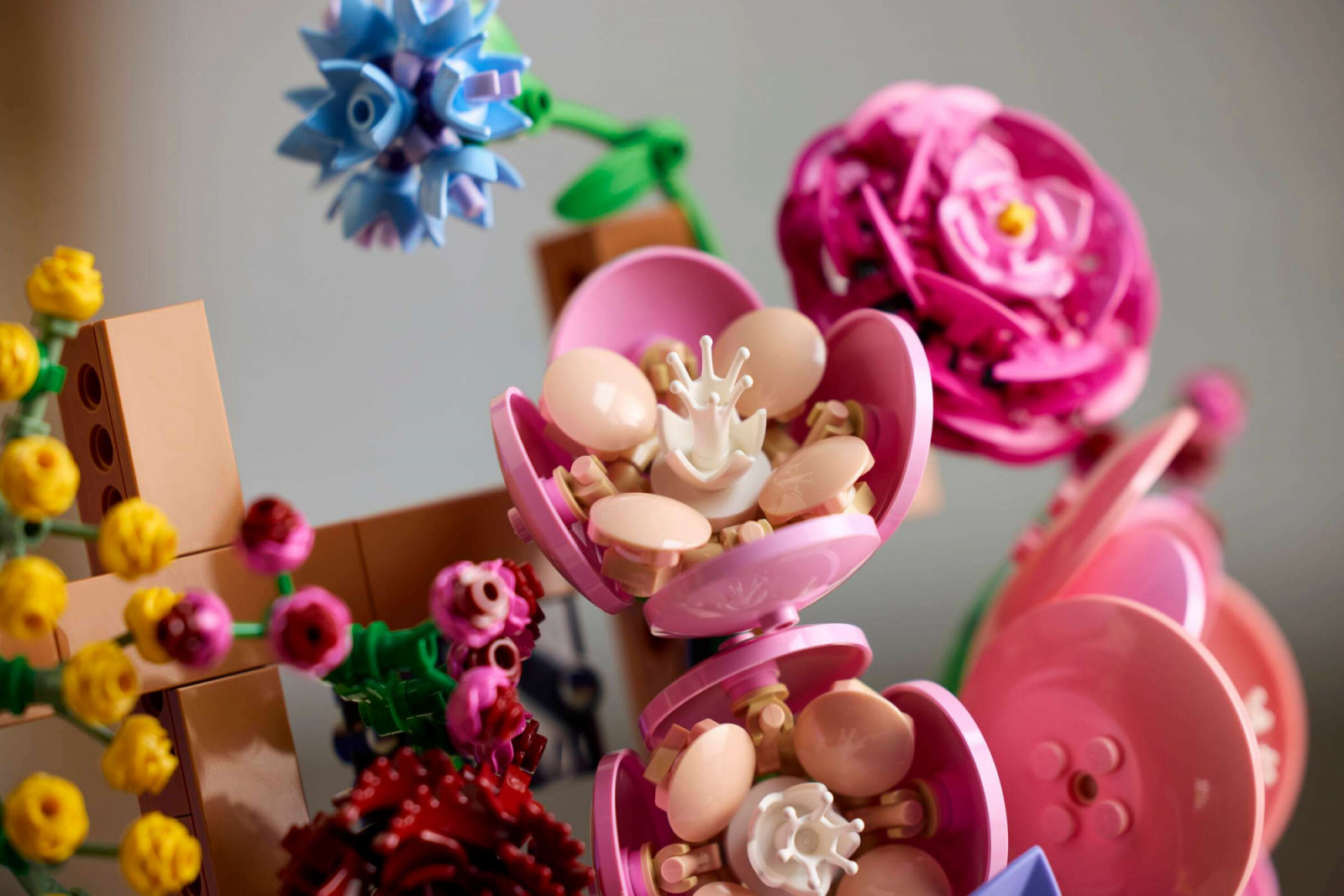 Detail of the camellia construction. The large pink bowl-shaped outer petals are formed from recoloured dish pieces in the new Warm Pink colour, with oval and egg elements clustered around a white crown piece to replicate the flower’s interior