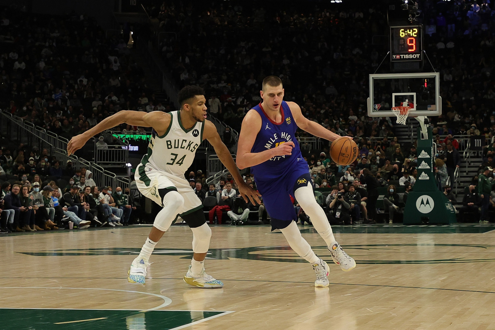 Nikola Jokic #15 of the Denver Nuggets is defended by Giannis Antetokounmpo #34 of the Milwaukee Bucks during a game at Fiserv Forum on January 30, 2022 in Milwaukee, Wisconsin. NOTE TO USER: User expressly acknowledges and agrees that, by downloading and or using this photograph, User is consenting to the terms and conditions of the Getty Images License Agreement. (Photo by Stacy Revere/Getty Images)