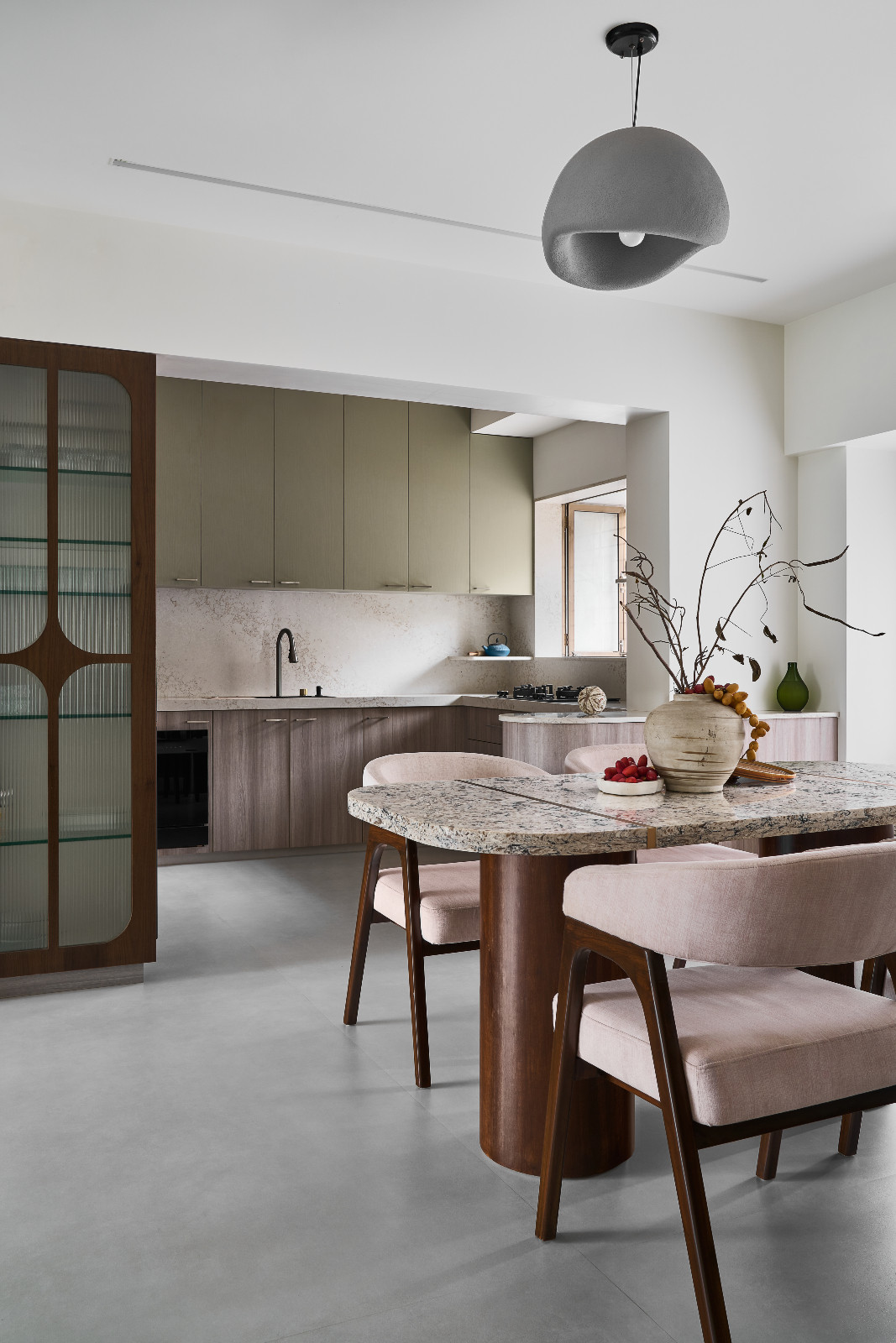 The dining room and kitchen of a family apartment in Mumbai, India designed by Dusq Studio