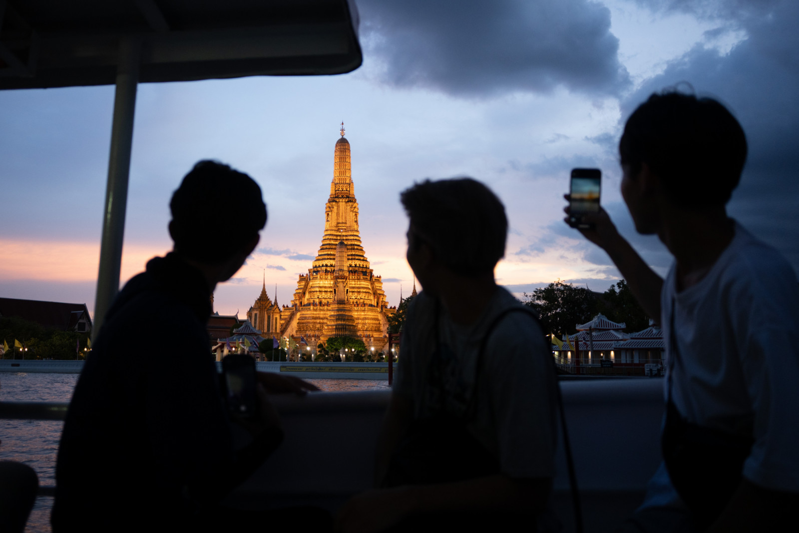 03 September 2025, Thailand, Bangkok: Passengers sit on a ferry in front of the Wat Arun temple. Photo: Sebastian Kahnert/dpa (Photo by Sebastian Kahnert/picture alliance via Getty Images)