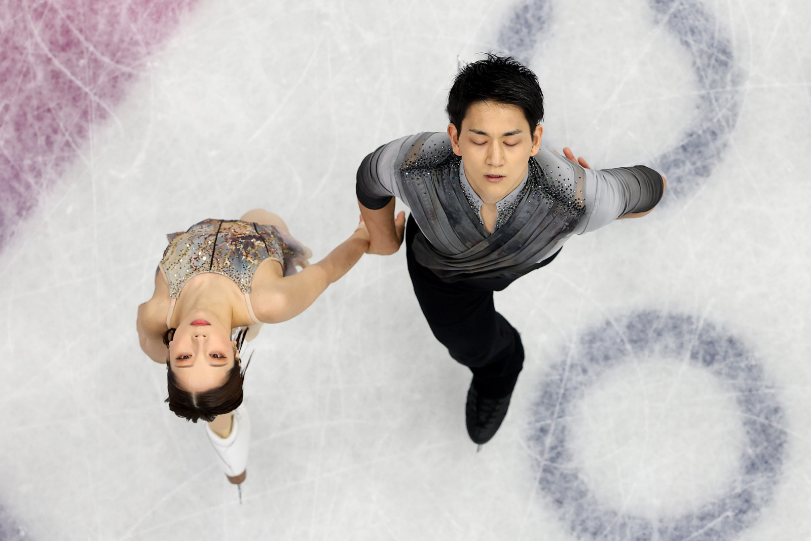 MILAN, ITALY - FEBRUARY 16: (EDITORS NOTE: Image was captured using a robotic camera positioned above the field of play.) Riku Miura and partner Ryuichi Kihara of Team Japan compete during Pair Skating - Free Skating on day ten of the Milano Cortina 2026 Winter Olympic games at Milano Ice Skating Arena on February 16, 2026 in Milan, Italy. (Photo by Jared C. Tilton/Getty Images)