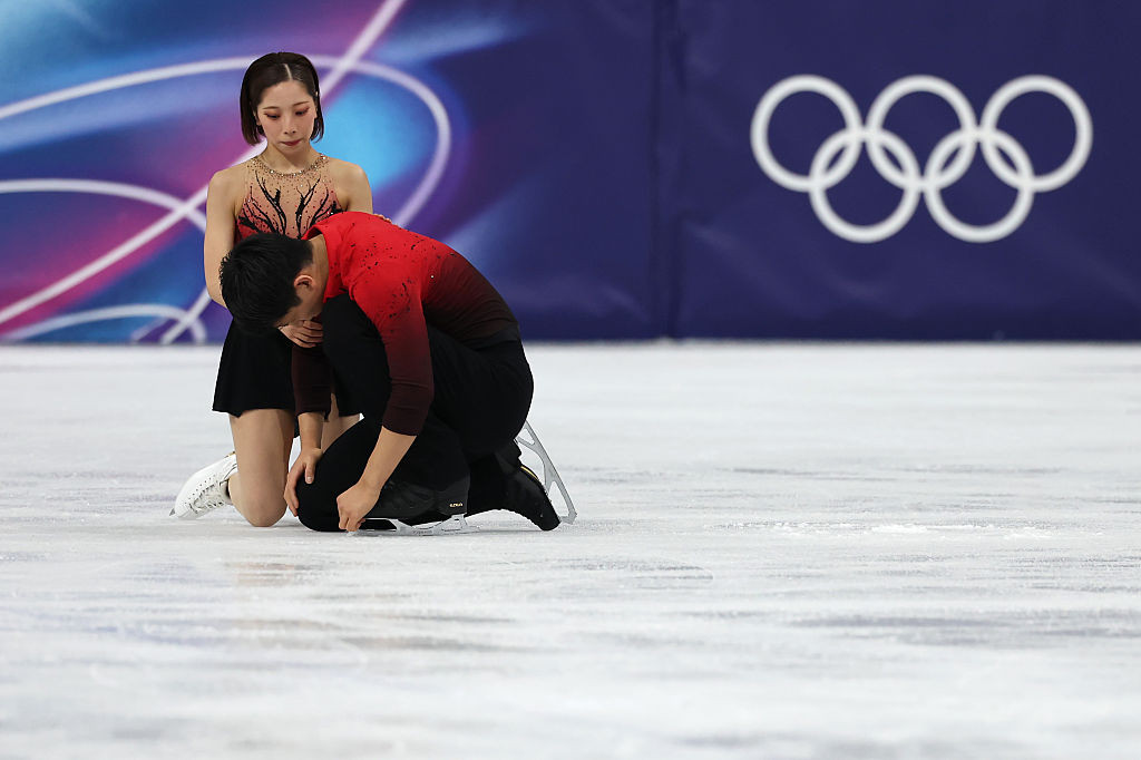 MILAN, ITALY - FEBRUARY 15: Riku Miura and partner Ryuichi Kihara of Team Japan react after competing in Pair Skating - Short Program on day nine of the Milano Cortina 2026 Winter Olympic games at Milano Ice Skating Arena on February 15, 2026 in Milan, Italy. (Photo by Elsa/Getty Images)