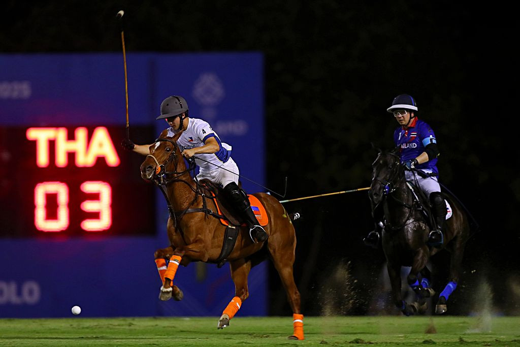SAMUT PRAKAN, THAILAND - DECEMBER 06: Eduardo Lopez No.4 of Philippines fights for ball during Equestrian Polo match mixed 2-4 Goals Preliminary - Group A between Philippines v Thailand of the 33rd SEA Games on December 06, 2025 in VS Sports Club, Samut Prakan, Thailand. (Photo by Thananuwat Srirasant/Getty Images)