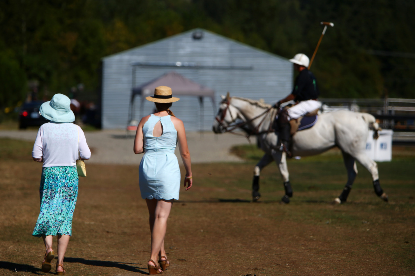Women in hats leave the event during a Polo Party hosted by Seattle Polo & Equestrian Club in Enumclaw, Sunday, Aug. 14, 2016. Wearing their best hats and garden party attire, attendees gathered to watch polo matches, picnic, divot stomp, and socialize. (Genna Martin, seattlepi.com) (Photo by GENNA MARTIN/San Francisco Chronicle via Getty Images)