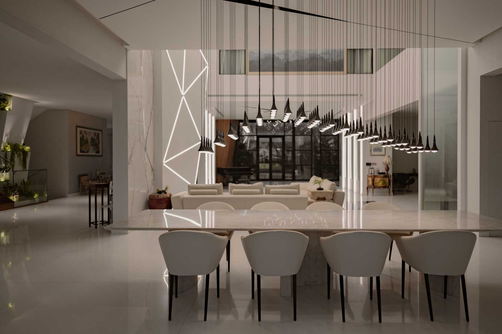 The multigenerational home’s multiple lighting installations reinforces lighting as a unifying architectural gesture across the open-plan living space