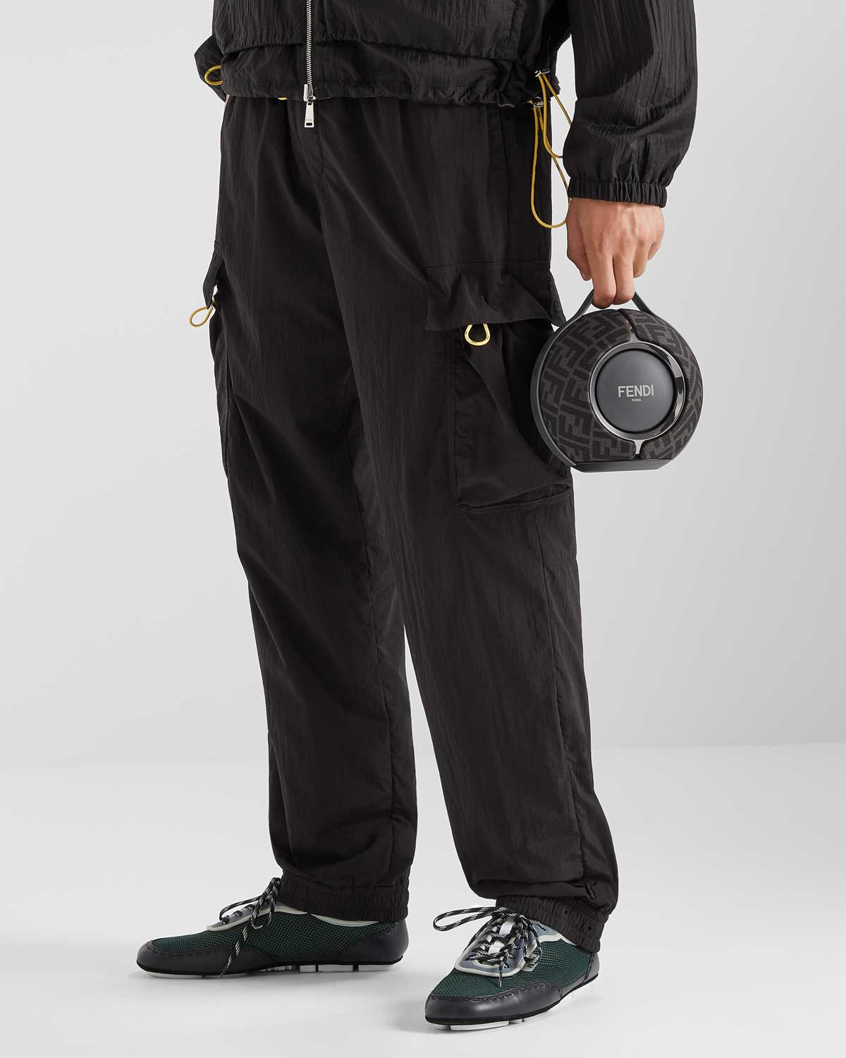 A model holding the Fendi x Devialet Mania portable speaker