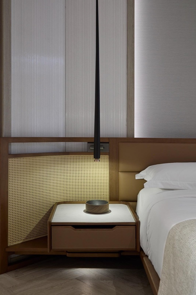 Rattan panels and bespoke timber joinery in a guest suite: Chan’s design language strips back ornament to let material and light do the work