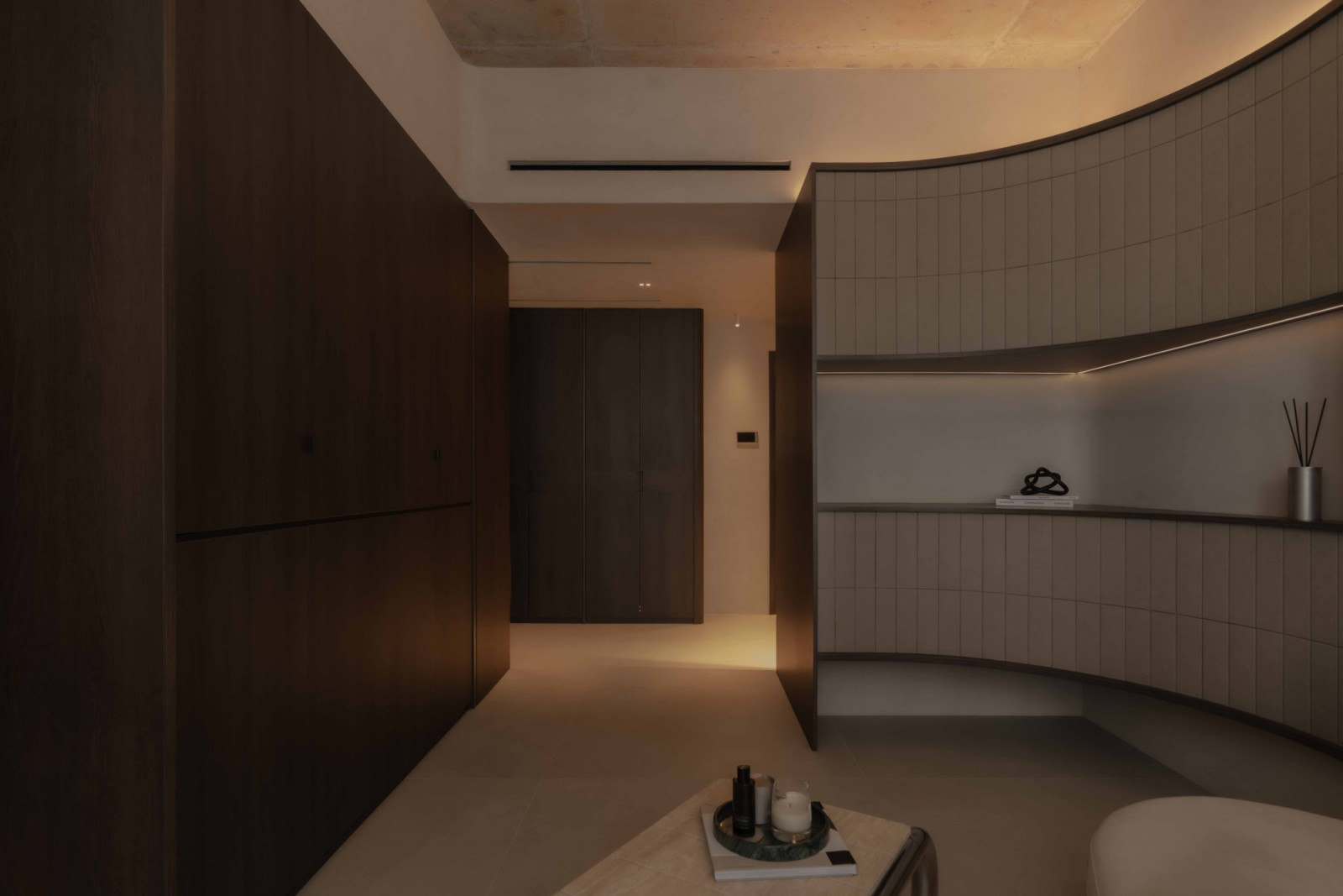 Within this sculpted living room, the Ltech system is embedded into the carpentry, uniting form, function and intelligent control