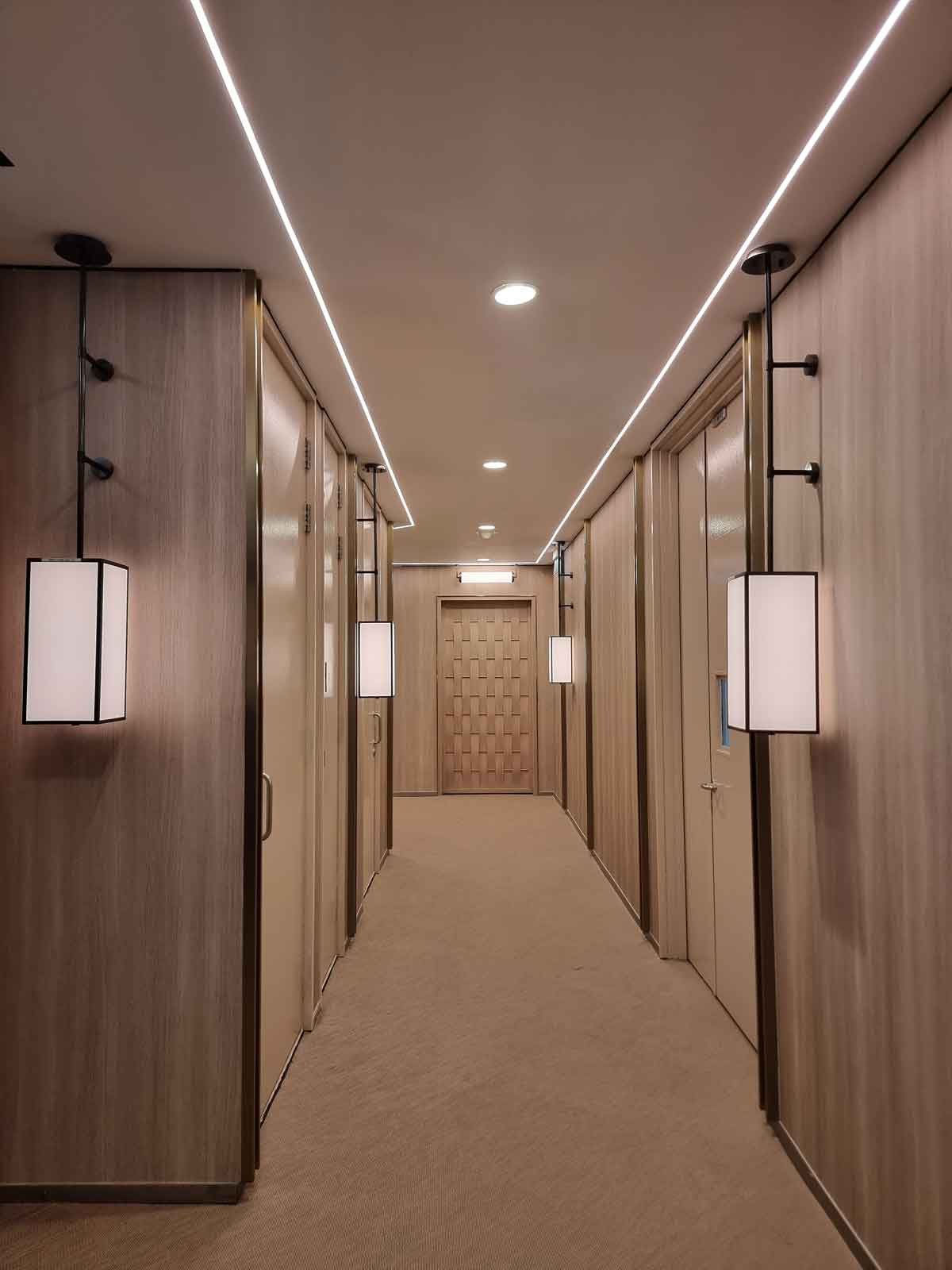 The front door makes a bold design statement at the end of the elegant corridor