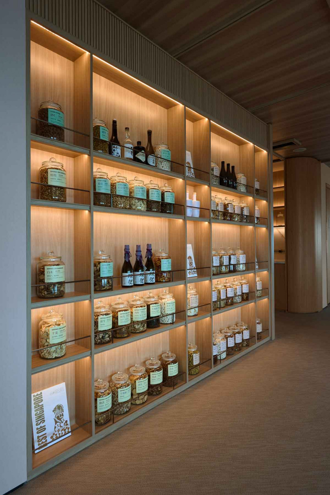 Backlit shelves accentuate the company’s products with a soft glow