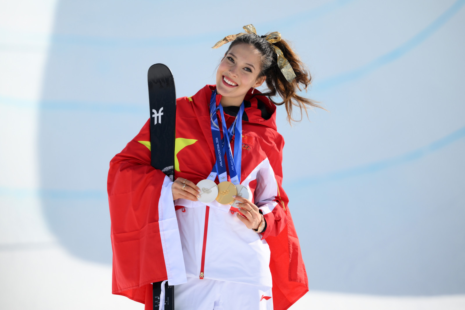 LIVIGNO, ITALY - FEBRUARY 22: Gold medalist Ailing Eileen Gu of Team People’s Republic of China celebrates during the medal ceremony with her collection of medals for the Women's Freeski Halfpipe Final on day sixteen of the Milano Cortina 2026 Winter Olympic games at Livigno Air Park on February 22, 2026 in Livigno, Italy. (Photo by David Ramos/Getty Images)
