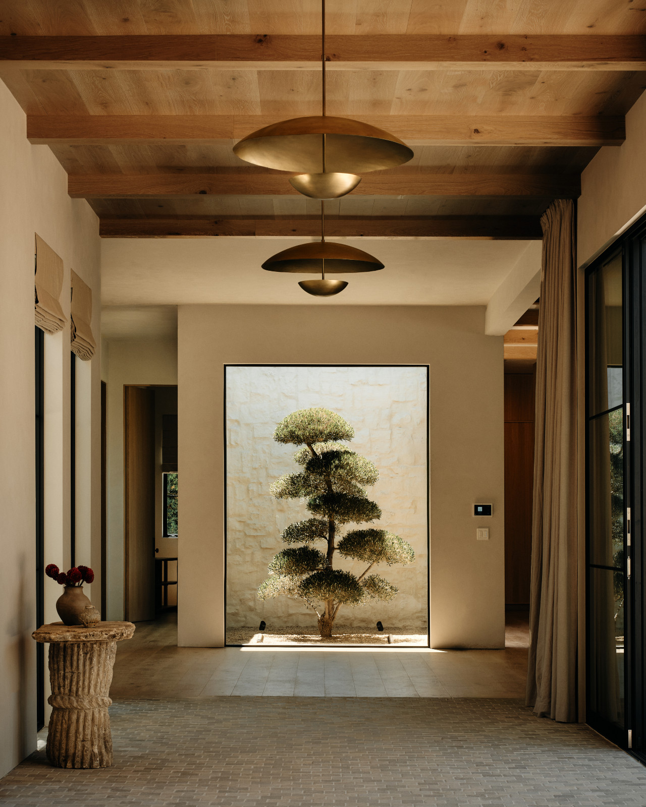 A glimpse of the courtyard in a Tuscan-inspired Los Angeles, California home designed by Lidan Sfadia and Edward Grigoryan