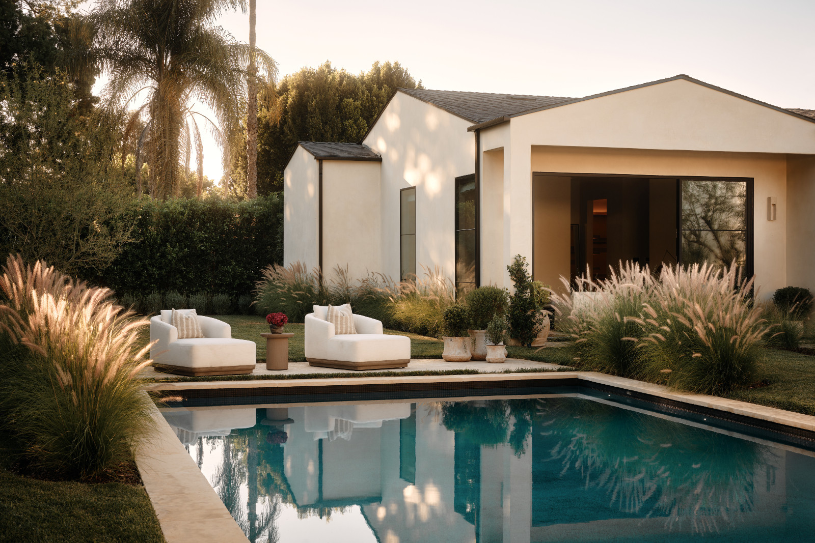 The outdoor swimming pool area of a Tuscan-inspired Los Angeles, California home designed by Lidan Sfadia and Edward Grigoryan