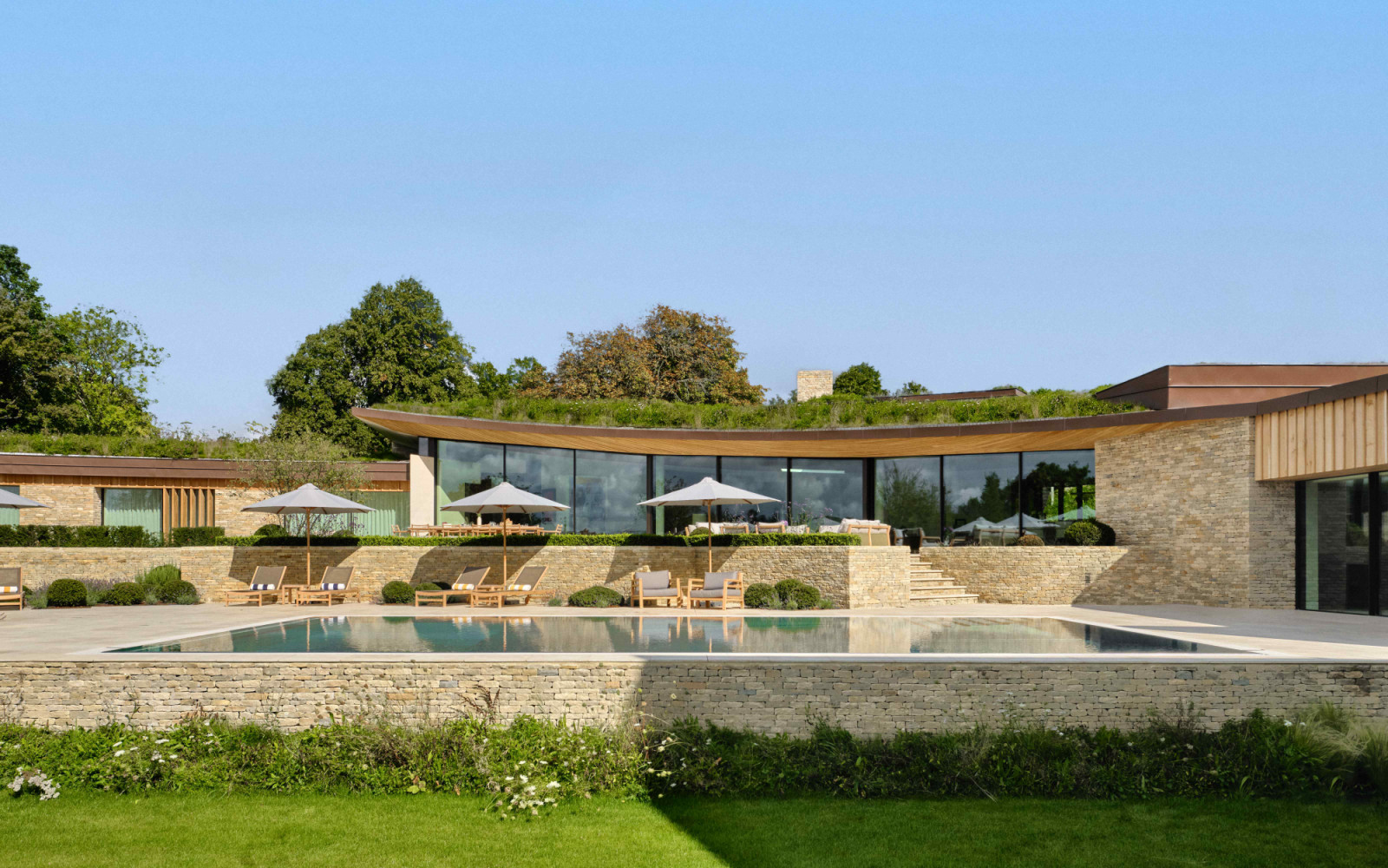 The wing extension with a curved wildflower green roof