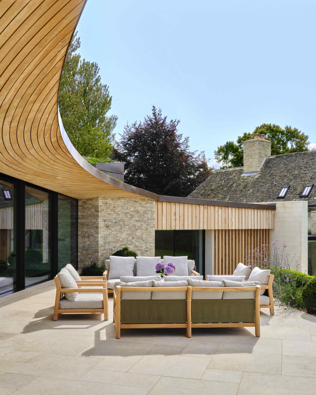 The large, curved overhang provides passive summer shading