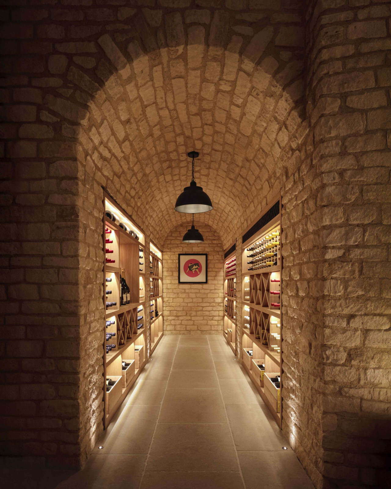 The wine cellar features bespoke joinery recessed into the arched brickwork