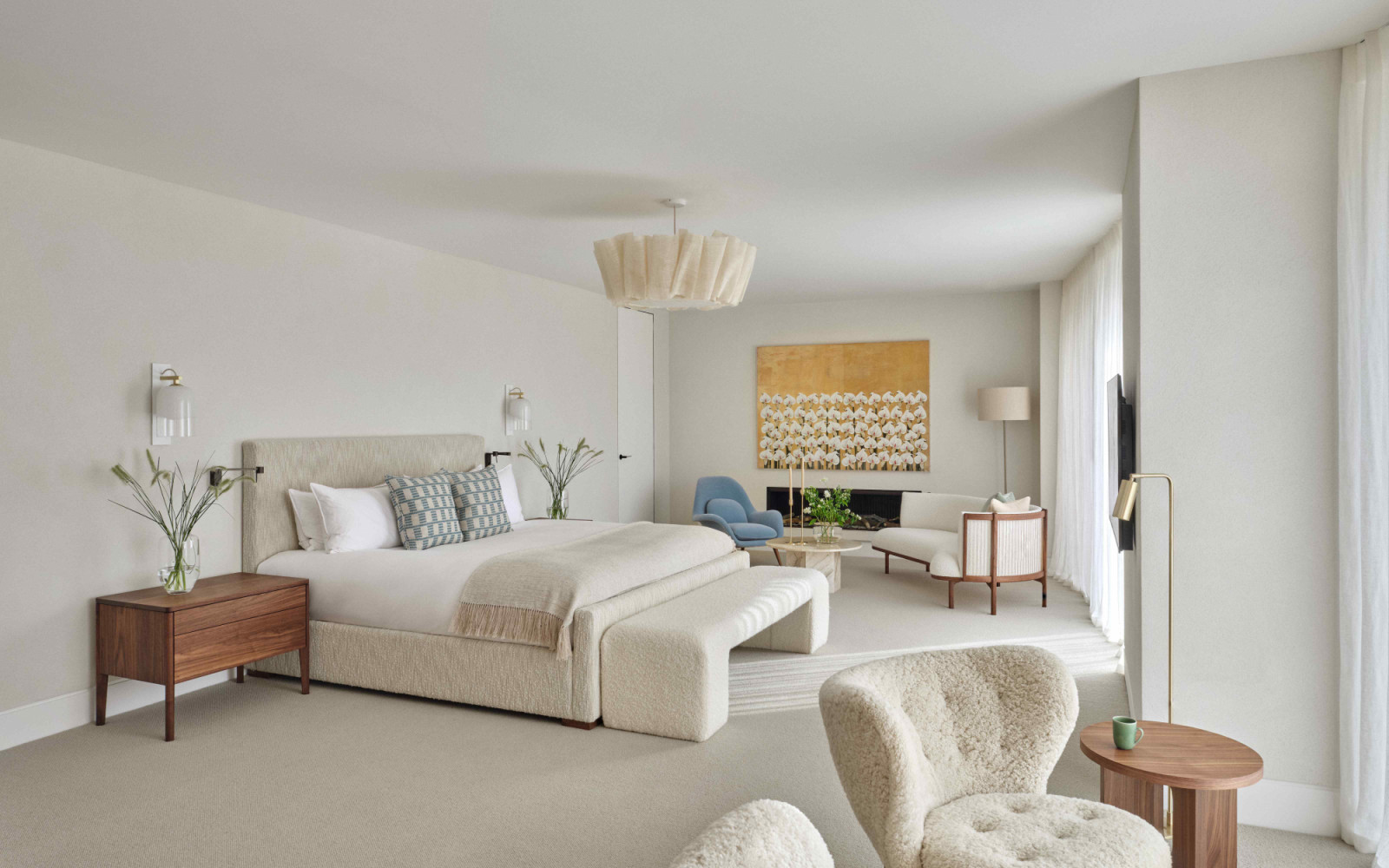 The modern design in the primary suite embraces warmth, texture and character