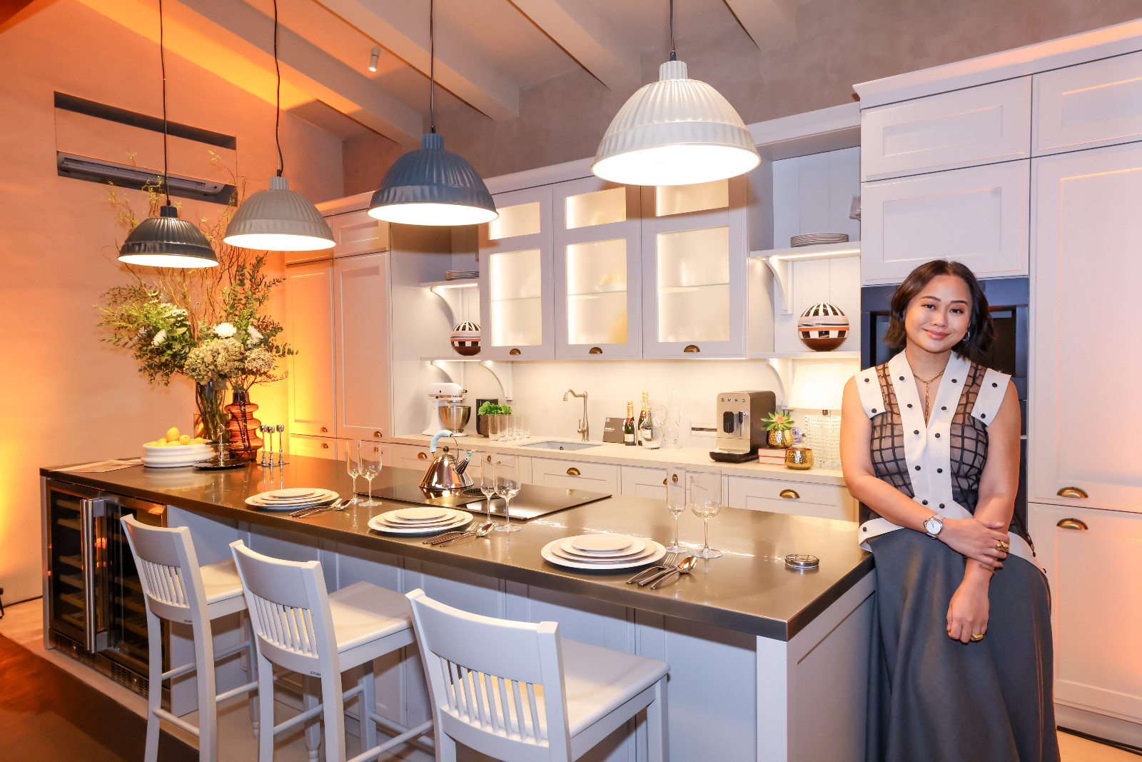 Interior designer Rossy Rojales with the kitchen vignette she designed for Scavolini's new showroom at the Proscenium at Rockwell