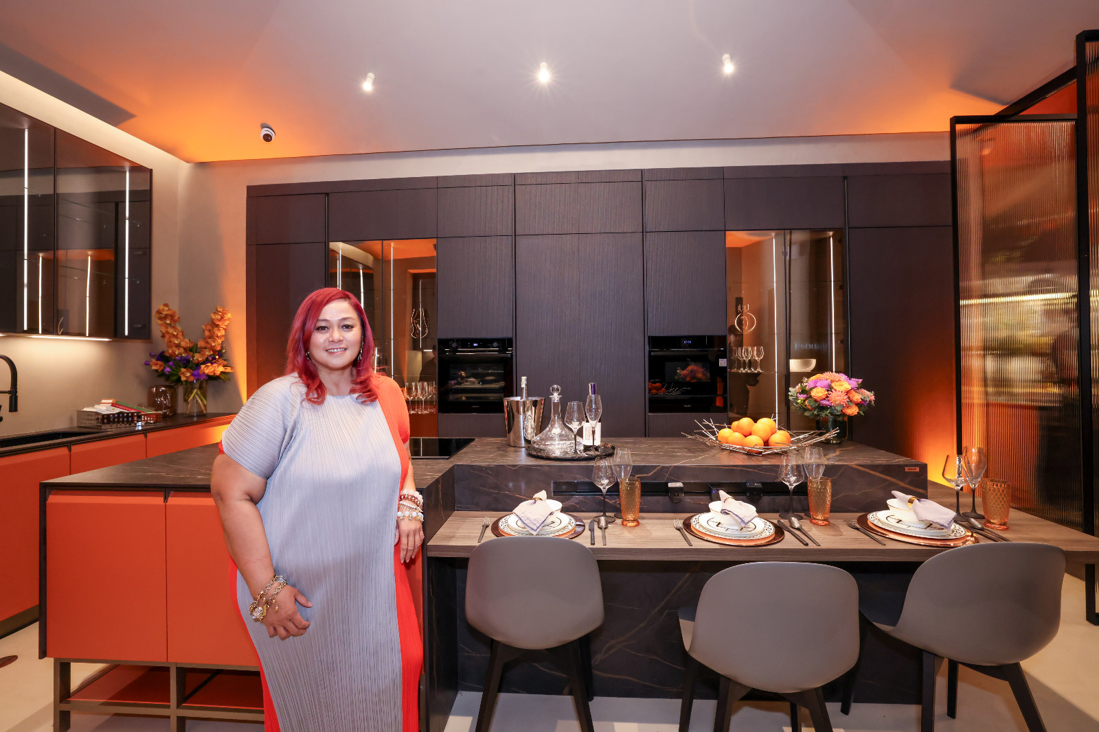 Interior designer Cecil Ravelas with the kitchen vignette she designed for Scavolini's new showroom at the Proscenium at Rockwell