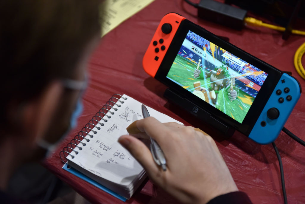 A competitor makes notes while playing Pokémon on a Nintendo Switch console during the 2022 Pokémon World Championships in London in 2022 (Images: Getty Images)