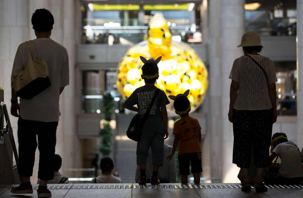 Boys wearing Pikachu-shaped sun visors arrive for an event hosted by the Pokémon company in Japan (Images: Getty Images)