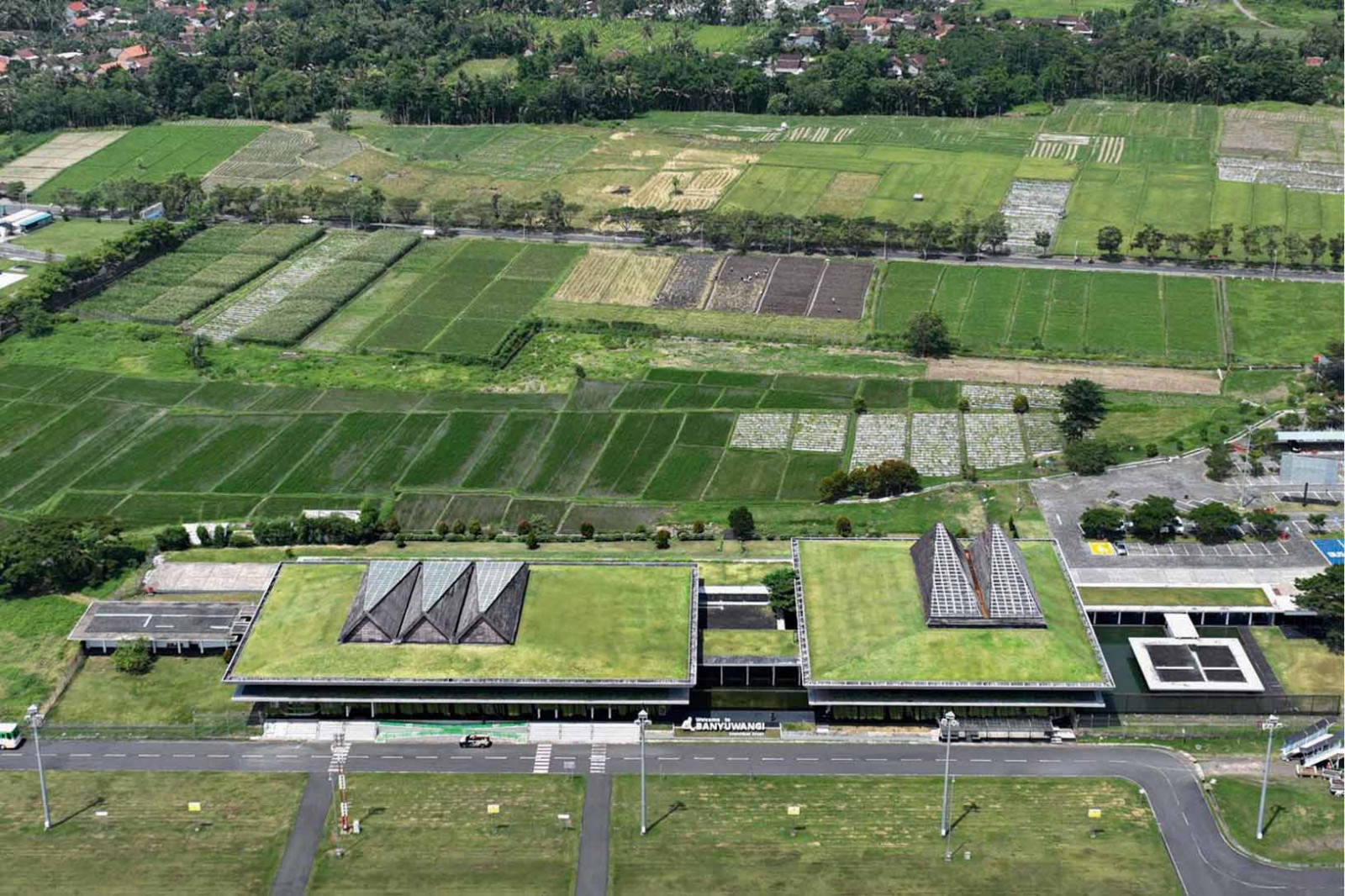 An aerial view of Banyuwangi International Airport shows how its grass-covered roofs merge with the surrounding landscape. (Photo by Mario Wibowo)