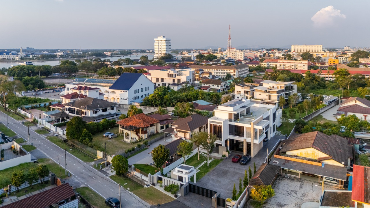 An aerial view of the three-level residence among Muar’s mixed residential and heritage streetscape, with the town centre and river visible to the north