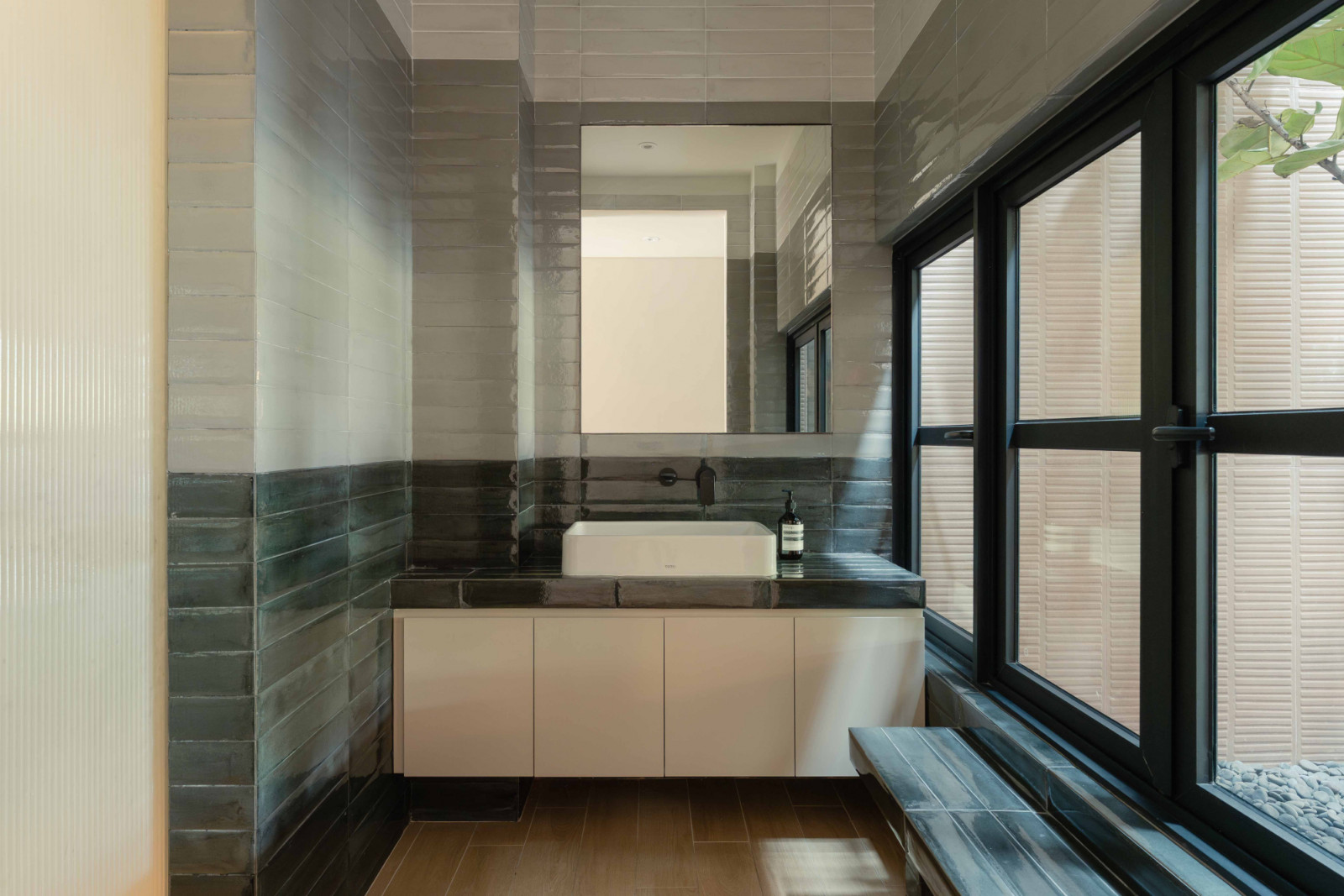 The new powder room on the first storey enjoys natural light from the courtyard
