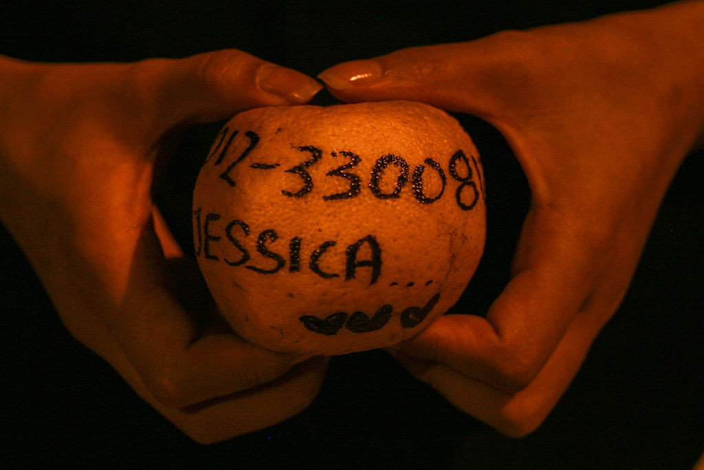 KLANG, MALAYSIA - FEBRUARY 22:  A woman holds an orange with a prayer message during Chap Goh Meh celebrations to mark the end of Chinese New Year at Port Klang outside Kuala Lumpur on February 22, 2016 in Klang, Malaysia. The 15th night of the Chinese New year it is celebrated with prayers and offerings to mark the end of the Chinese New Year.   Legend has seen young, unmarried women throwing orange's into the lake hoping to find a good husband.   (Photo by Mohd Samsul Mohd Said/Getty Images)