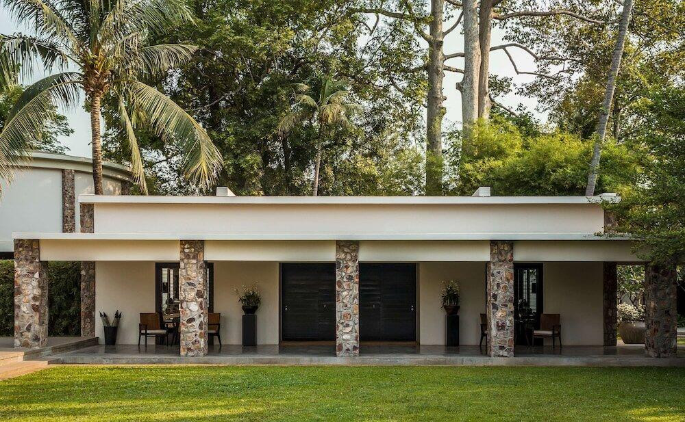 The flat-roofed guest wing with its distinctive rubble-stone columns, characteristic of Mondet’s New Khmer architecture, which fused mid-century modernist forms with local Cambodian materials