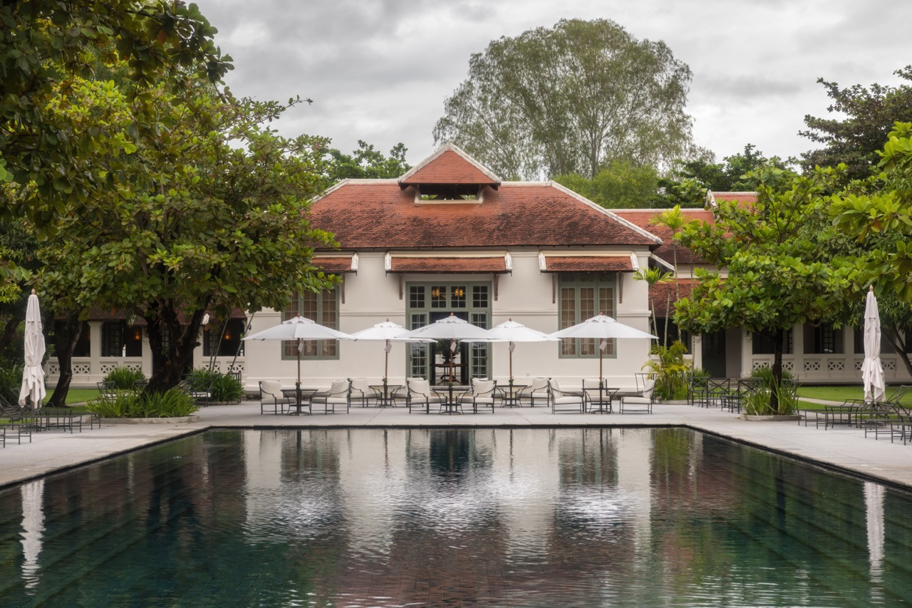 The central pool and courtyard, around which the 24 suites are arranged. The symmetrical layout follows the original hospital compound, with the main building reflected in the water.