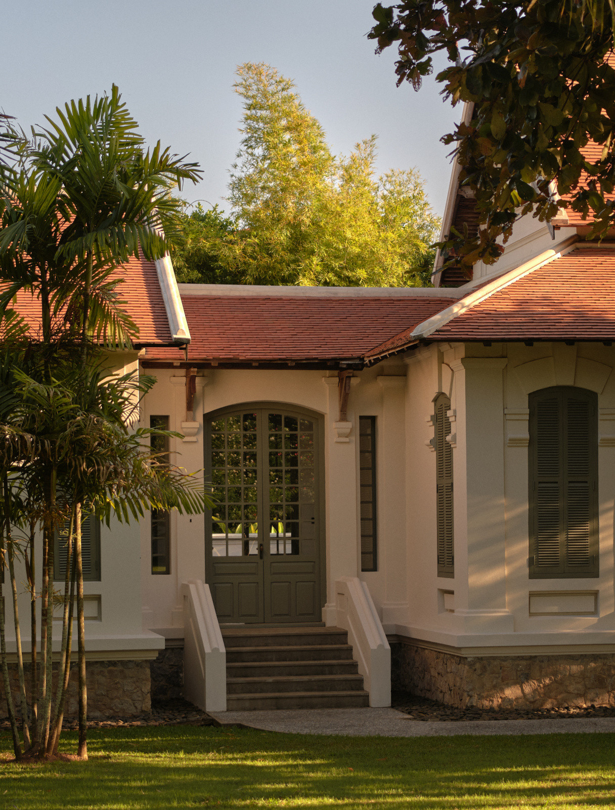 A suite entrance in one of the original French colonial ward building where the terracotta roof tiles and louvred shutters were restored under UNESCO guidelines, with materials sourced locally to match the originals