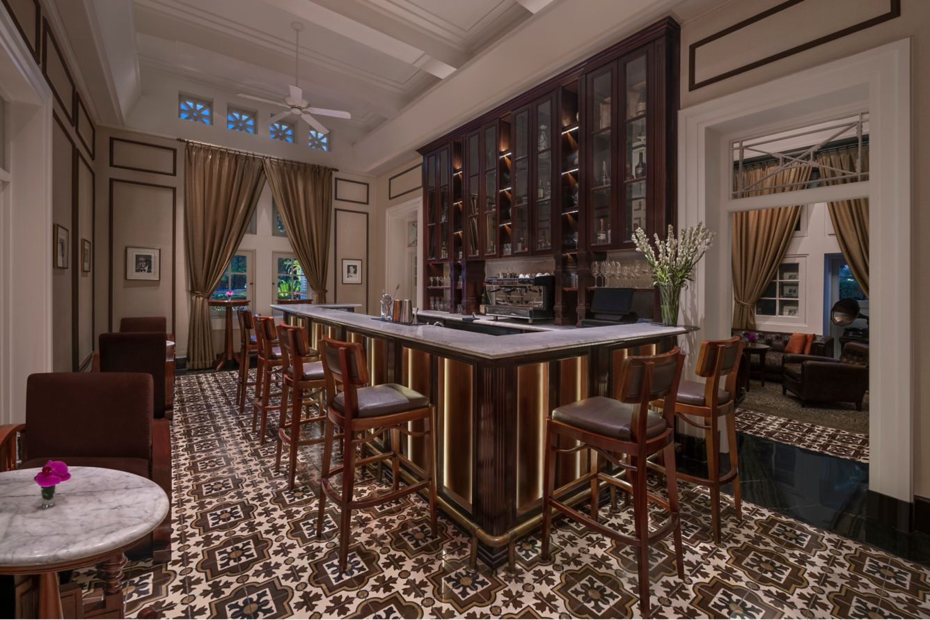 The Hermitage Lounge has encaustic cement floor tiles and original high clerestory windows with geometric fretwork