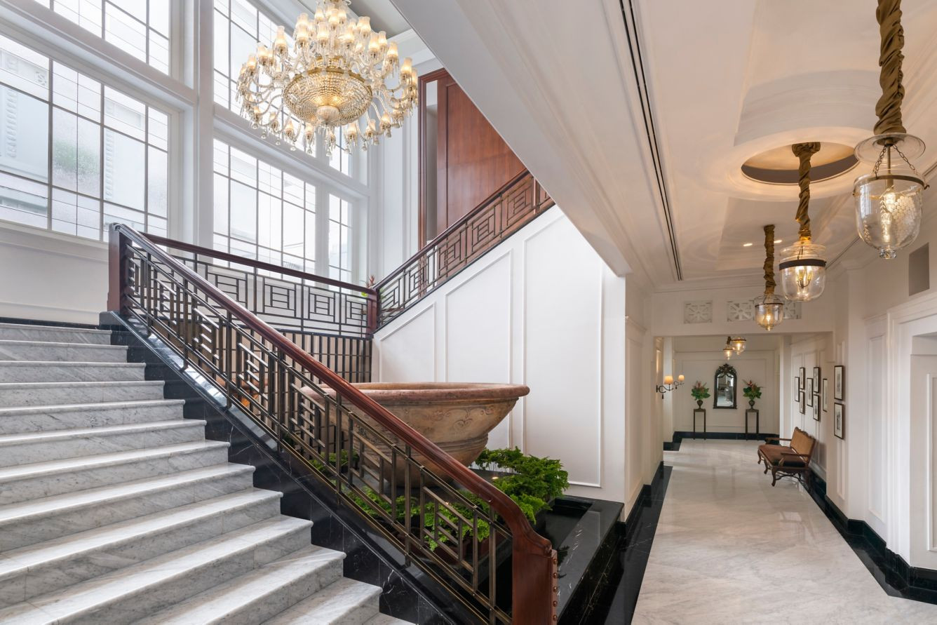 The marble staircase in the original building’s lobby, with art deco ironwork balustrade. Wall dividers, window fittings and cornicing throughout the heritage structure are original to the 1923 building