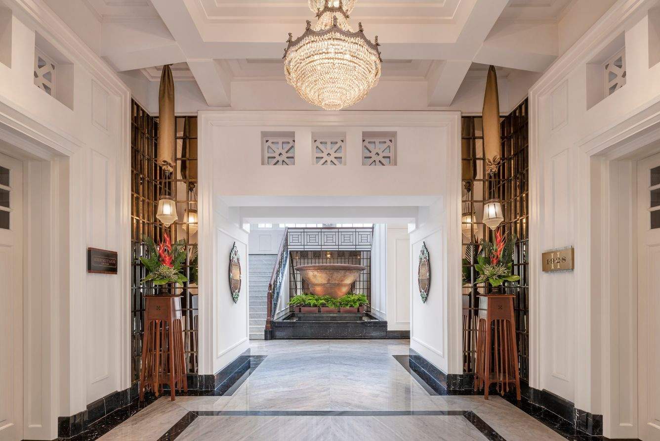 The entrance lobby of the original Telefoongebouw, with a coffered ceiling, geometric fretwork vents and original door frames intact