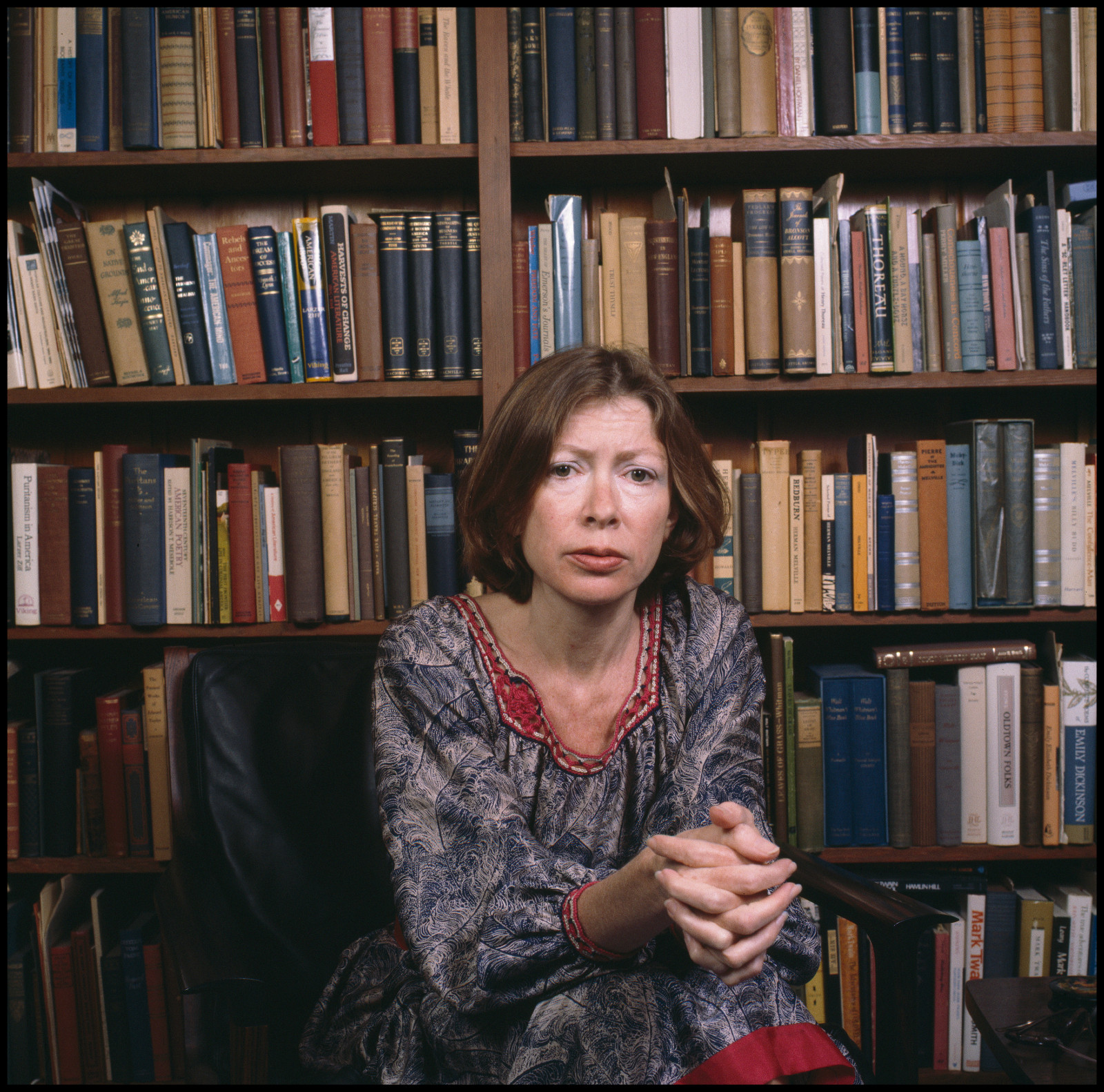 Portrait of American author Joan Didion as she sits in a chair in front of a bookshelf, Berkeley, California, April 1981. (Photo by Janet Fries/Getty Images)