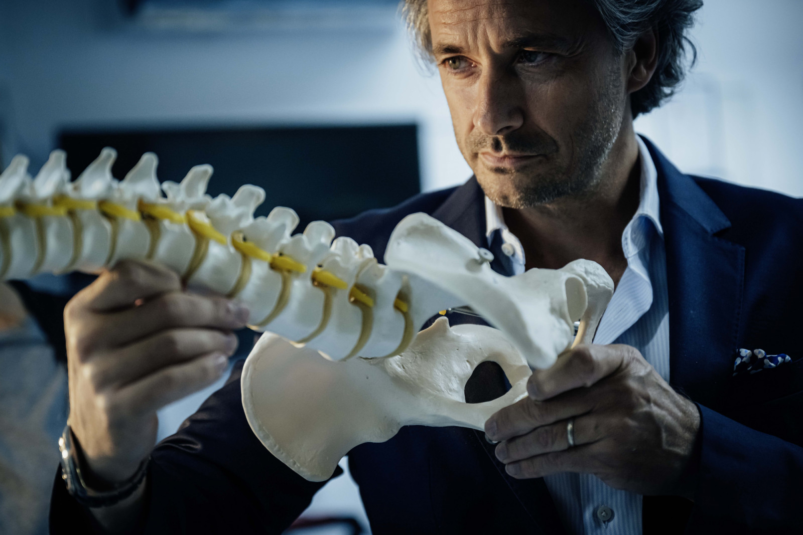 Neuroscientist Grégoire Courtine inspecting an anatomical model of a spine at the research laboratory at the Swiss Federal Technology Institute of Lausanne.  As an avid climber, Courtine is deeply affected by seeing young athletes paralysed by sporting injuries. He has dedicated his life to treating these injuries.