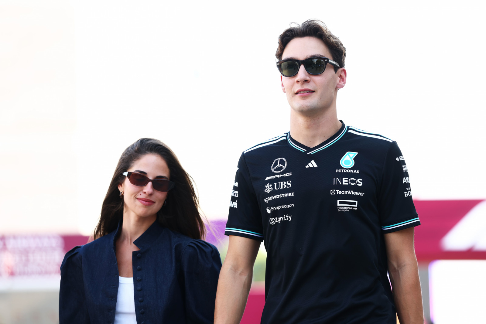 LUSAIL CITY, QATAR - NOVEMBER 29: George Russell of Great Britain and Mercedes AMG Petronas F1 Team and Carmen Montero Mundt arrive in the Paddock prior to the Sprint ahead of the F1 Grand Prix of Qatar at Lusail International Circuit on November 29, 2025 in Lusail City, Qatar. (Photo by Clive Rose - Formula 1/Formula 1 via Getty Images)