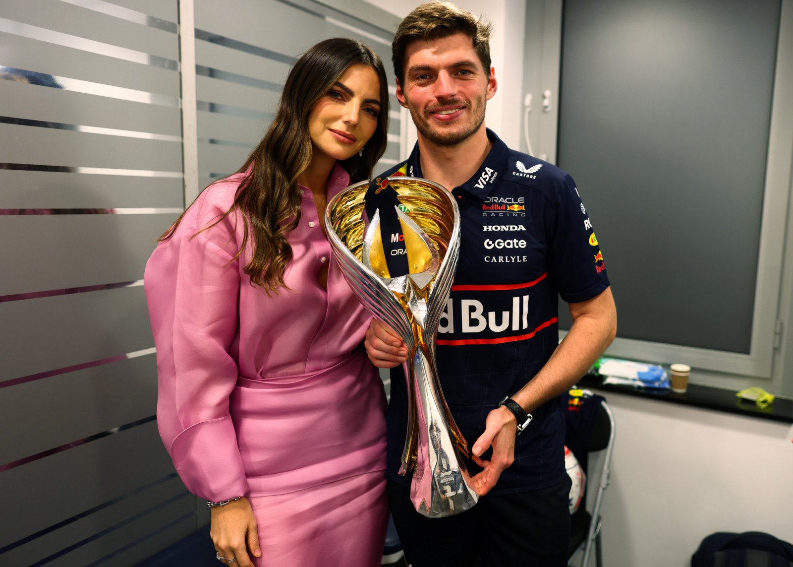 ABU DHABI, UNITED ARAB EMIRATES - DECEMBER 07: Race winner Max Verstappen of the Netherlands and Oracle Red Bull Racing and Kelly Piquet celebrate with the trophy during the F1 Grand Prix of Abu Dhabi at Yas Marina Circuit on December 07, 2025 in Abu Dhabi, United Arab Emirates. (Photo by Mark Thompson/Getty Images)