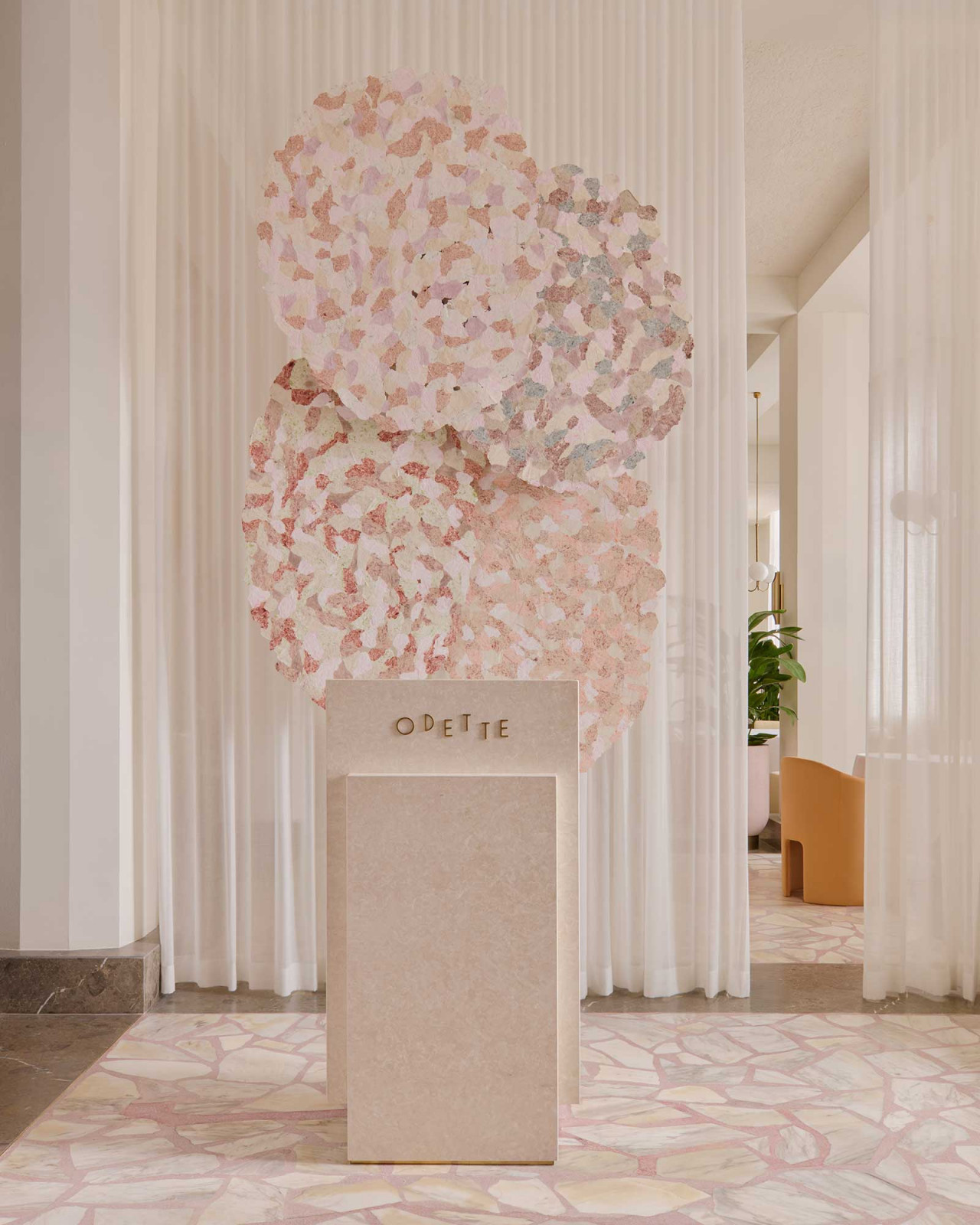 Th entrance of Odette, with Dawn Ng’s paper artwork mounted above the stone signage plinth, following the restaurant’s 2025 renovation by Nice Projects (Photo: Odette)