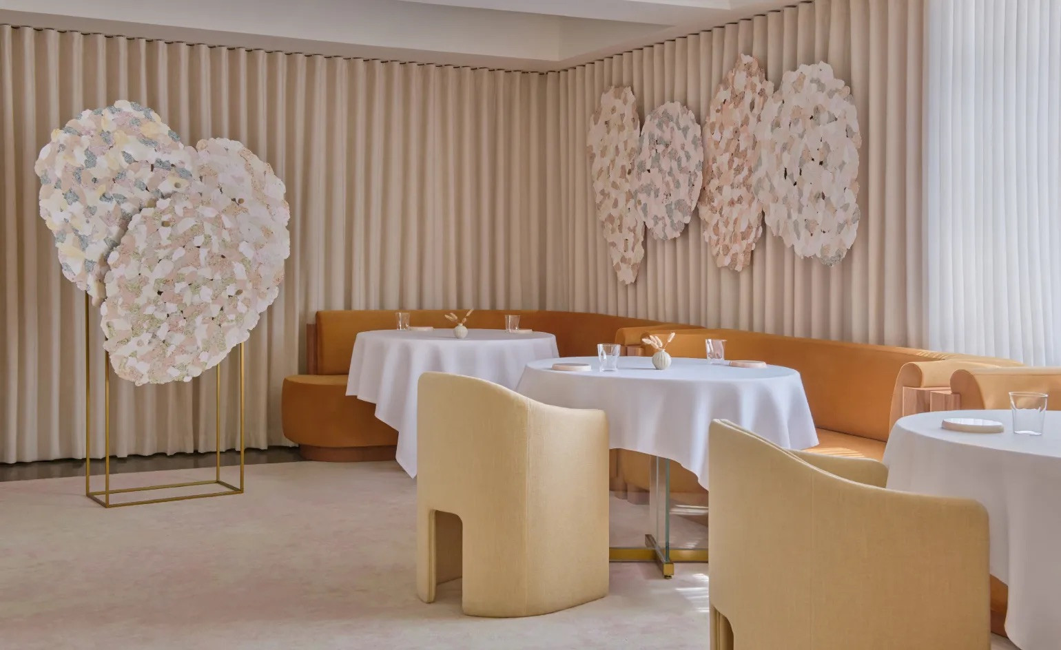 Dawn Ng's paper artworks in the dining room of Odette, alongside the amber banquette seating (Photo: Odette)