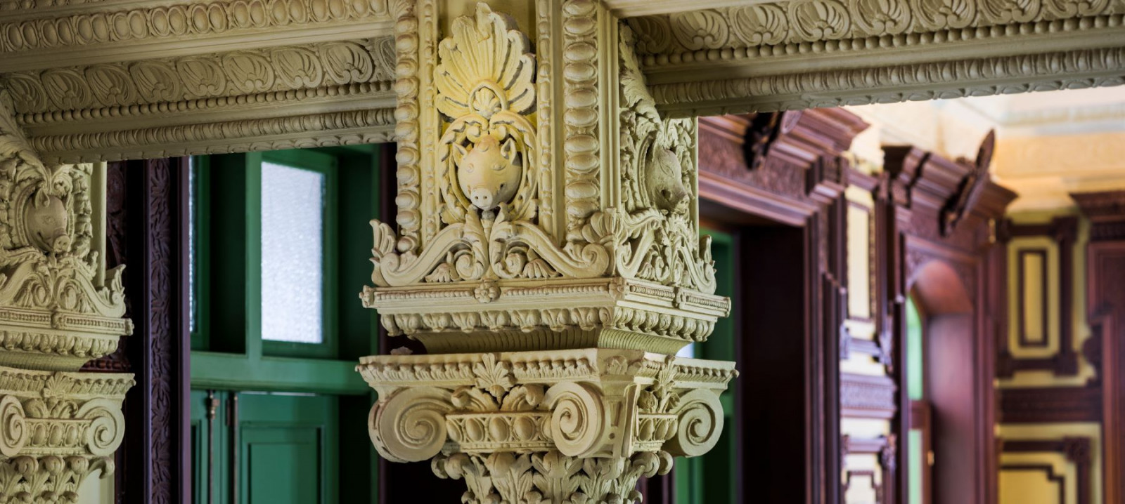 A capital from one of the interior columns of The House on Sathorn, with the boar's head motif original to the 1889 building