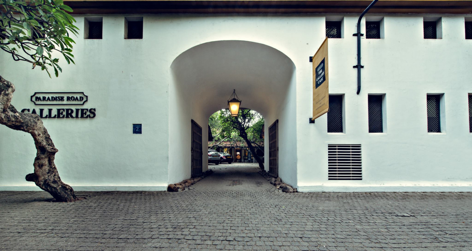 The entrance to Paradise Road Galleries and The Gallery Café on Alfred House Road, Colombo, accessed through an arched passageway in the compound wall