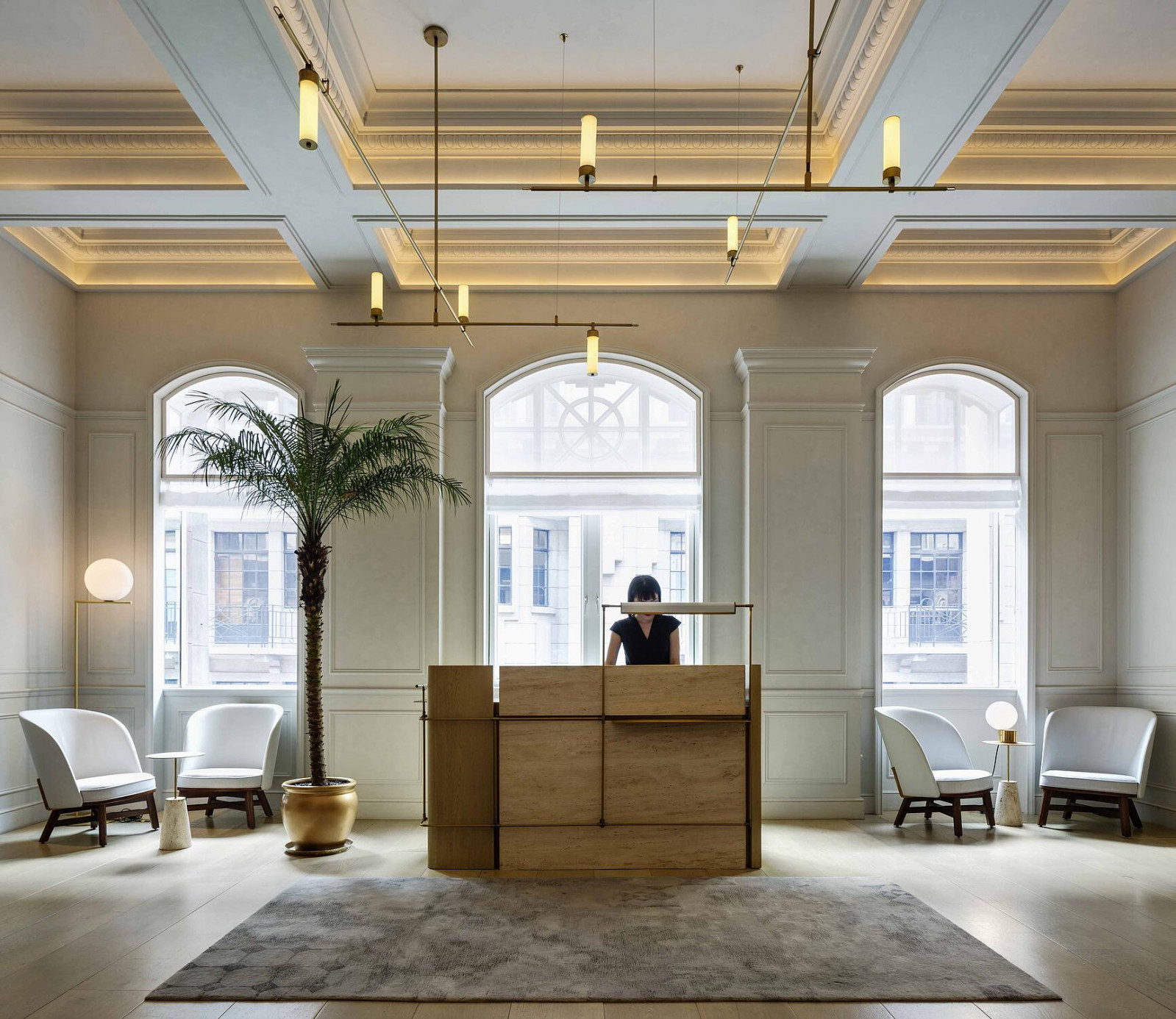 The entrance foyer of Jean-Georges at Three on the Bund, with the restored 1916 plasterwork cornices and arched heritage windows retained within Neri&Hu’s redesign